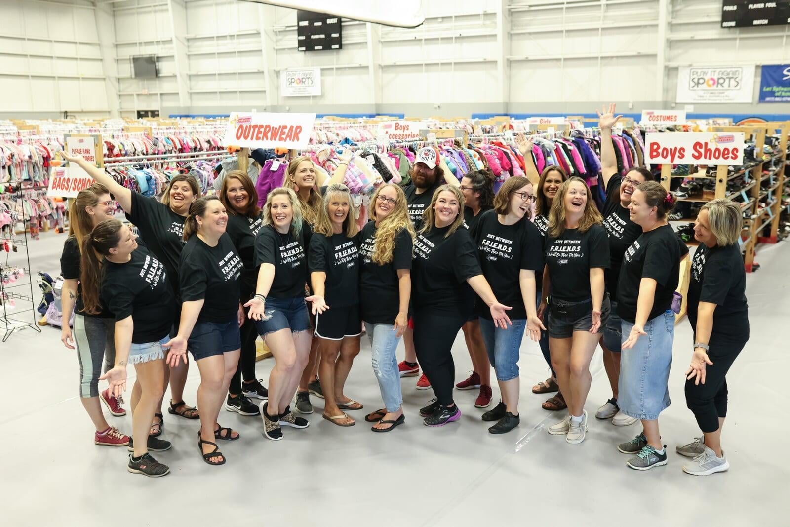 JBF Springfield team standing in front of rows of clothing